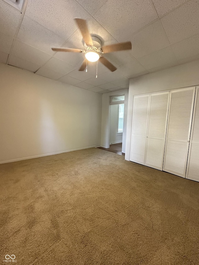 107 S Nebraska St, North Salem, IN 46165 - unfurnished bedroom featuring carpet flooring, a paneled ceiling, a closet, and ceiling fan