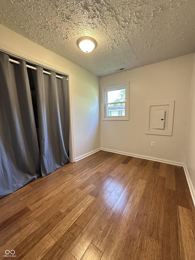 107 S Nebraska St, North Salem, IN 46165 - unfurnished room featuring wood finished floors, a textured ceiling, and electric panel