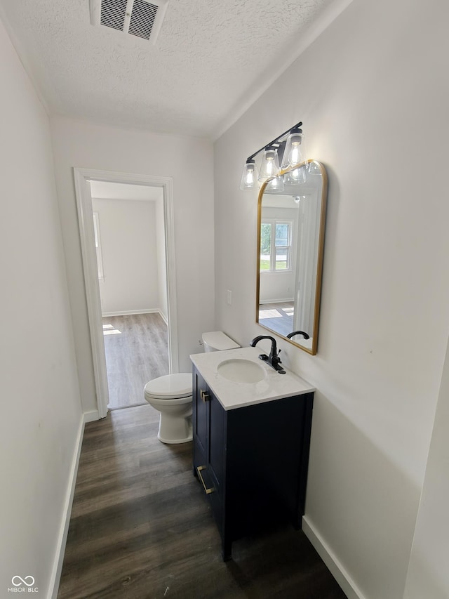 316 E Mechanic St, Shelbyville, IN 46176 - half bath featuring a textured ceiling, wood finished floors, and vanity