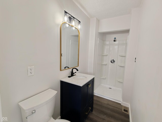 316 E Mechanic St, Shelbyville, IN 46176 - bathroom featuring vanity, wood finished floors, a textured ceiling, and a shower