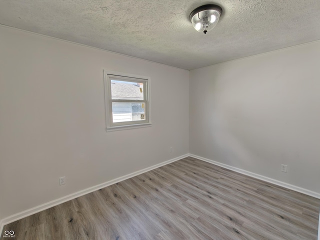 316 E Mechanic St, Shelbyville, IN 46176 - spare room with wood finished floors and a textured ceiling
