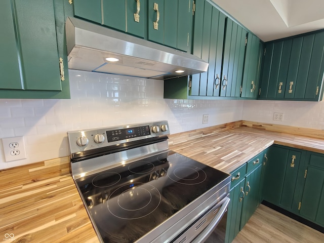 316 E Mechanic St, Shelbyville, IN 46176 - kitchen with stainless steel electric range, butcher block counters, under cabinet range hood, and tasteful backsplash
