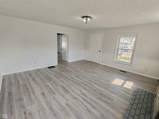 316 E Mechanic St, Shelbyville, IN 46176 - unfurnished room featuring wood finished floors, a textured ceiling, and a wainscoted wall