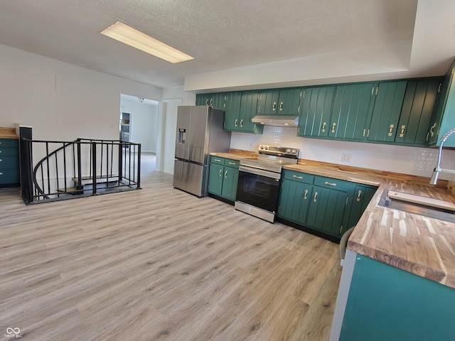 316 E Mechanic St, Shelbyville, IN 46176 - kitchen featuring stainless steel appliances, butcher block counters, light wood-style floors, under cabinet range hood, and a textured ceiling