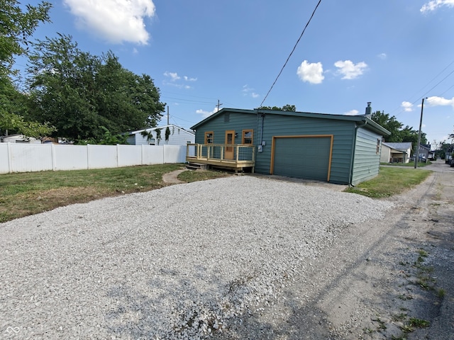 316 E Mechanic St, Shelbyville, IN 46176 - view of side of property with gravel driveway, an attached garage, and a wooden deck