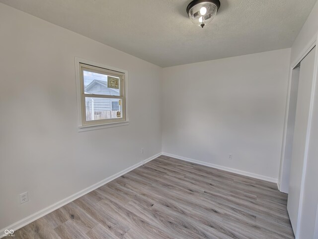 316 E Mechanic St, Shelbyville, IN 46176 - unfurnished room featuring light wood-style floors and a textured ceiling