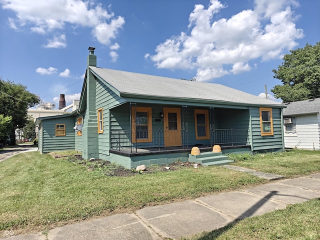 316 E Mechanic St, Shelbyville, IN 46176 - bungalow-style house featuring covered porch, a front yard, and a chimney