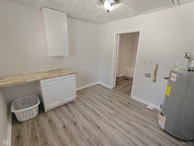 316 E Mechanic St, Shelbyville, IN 46176 - unfurnished dining area featuring electric water heater, light wood finished floors, attic access, and a textured ceiling