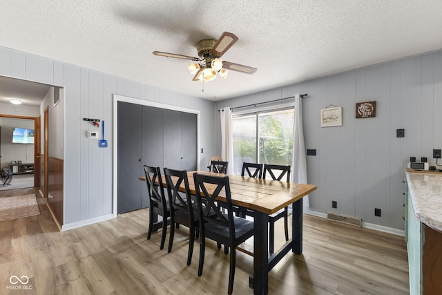 10816 N US Highway 231, Cloverdale, IN 46120 - dining room featuring light wood-type flooring, a ceiling fan, a textured ceiling, and a decorative wall