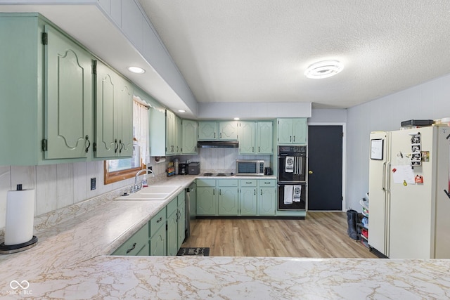 10816 N US Highway 231, Cloverdale, IN 46120 - kitchen with appliances with stainless steel finishes, green cabinetry, light countertops, light wood finished floors, and a textured ceiling
