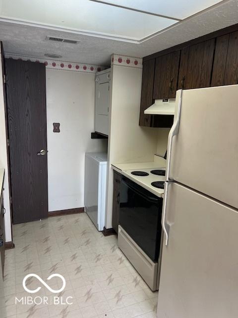 2804 Punto Alto Cir, Indianapolis, IN 46227 - kitchen with white appliances, custom exhaust hood, stacked washer and clothes dryer, light floors, and dark brown cabinets