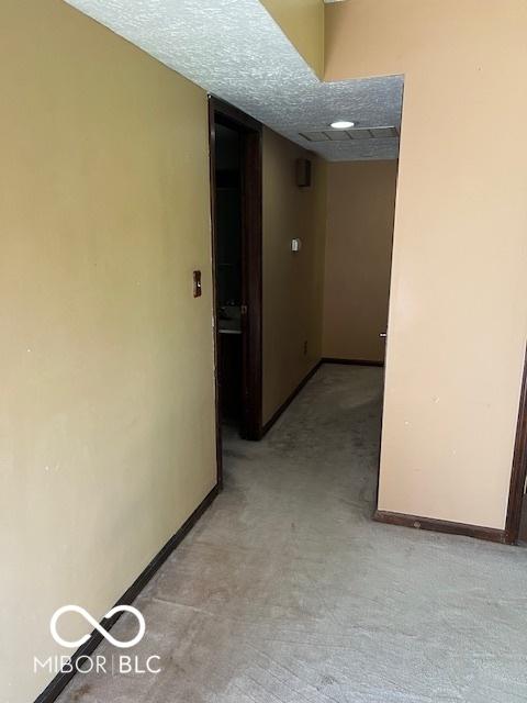 2804 Punto Alto Cir, Indianapolis, IN 46227 - corridor featuring baseboards and light colored carpet