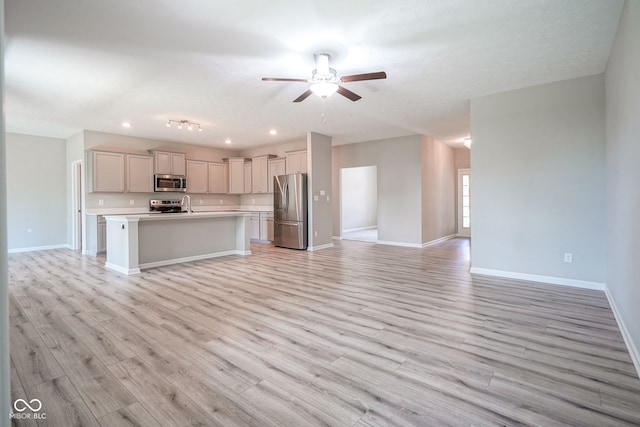 2541 Riviera Pl, Greenwood, IN 46143 - unfurnished living room with a ceiling fan, light wood-type flooring, and recessed lighting
