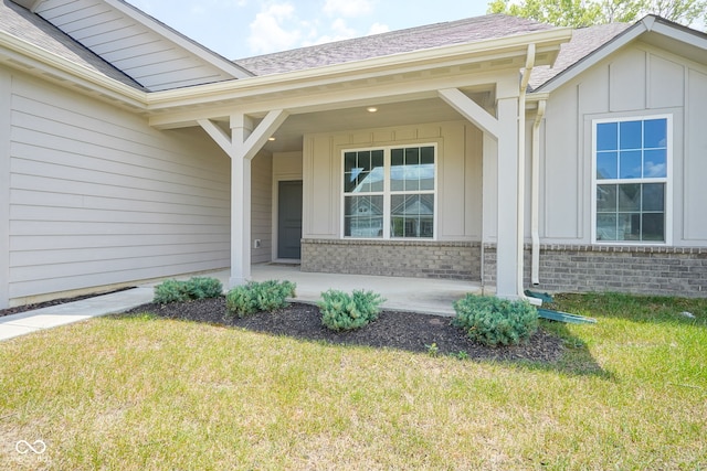2541 Riviera Pl, Greenwood, IN 46143 - entrance to property with board and batten siding, a lawn, covered porch, and a shingled roof