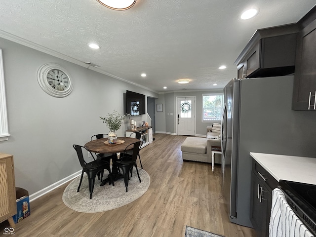 315 W N St, Crawfordsville, IN 47933 - dining space featuring light wood-style flooring, crown molding, and recessed lighting