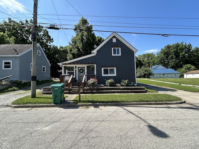 315 W N St, Crawfordsville, IN 47933 - view of front facade with board and batten siding and a front yard