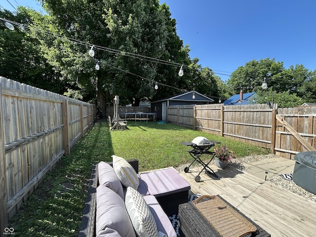315 W N St, Crawfordsville, IN 47933 - fenced backyard with a trampoline, a deck, and an outdoor hangout area