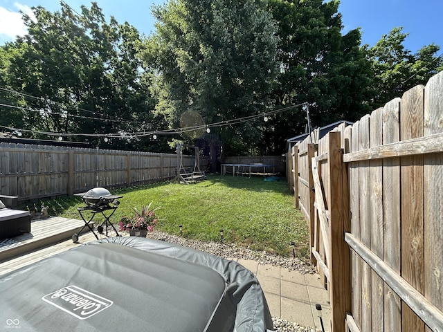315 W N St, Crawfordsville, IN 47933 - fenced backyard featuring a trampoline and a patio