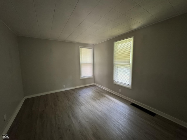 2002 N Audubon Rd, Indianapolis, IN 46218 - spare room featuring dark wood-style flooring and baseboards