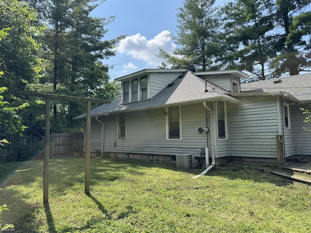 2002 N Audubon Rd, Indianapolis, IN 46218 - view of property exterior with a shingled roof and a central AC unit
