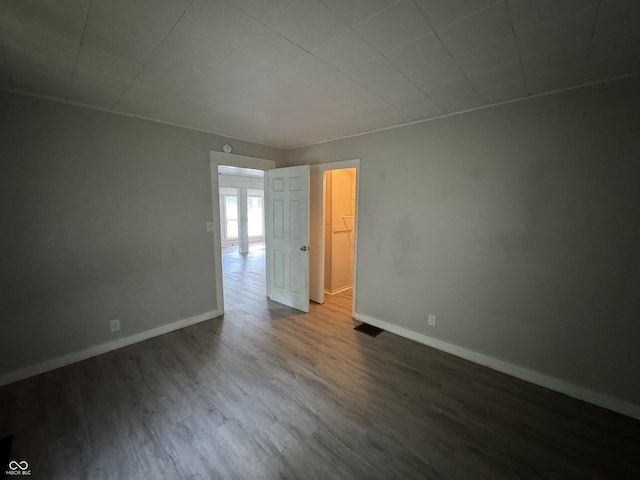 2002 N Audubon Rd, Indianapolis, IN 46218 - spare room featuring dark wood-style flooring and baseboards