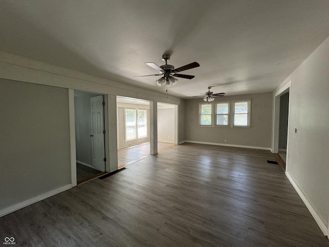 2002 N Audubon Rd, Indianapolis, IN 46218 - unfurnished bedroom with dark wood-style floors and a ceiling fan