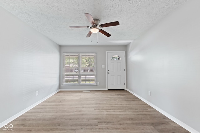 3102 Pawnee Dr, Indianapolis, IN 46235 - entryway with a textured ceiling, ceiling fan, and wood finished floors