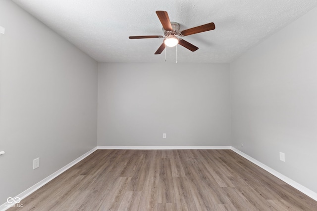3102 Pawnee Dr, Indianapolis, IN 46235 - spare room featuring wood finished floors, ceiling fan, and a textured ceiling