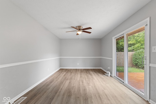 3102 Pawnee Dr, Indianapolis, IN 46235 - empty room featuring wood finished floors, a ceiling fan, and a textured ceiling