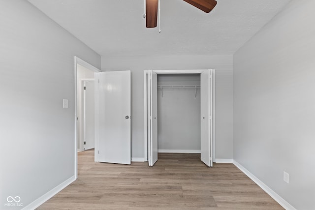3102 Pawnee Dr, Indianapolis, IN 46235 - unfurnished bedroom featuring wood finished floors, a closet, and a ceiling fan