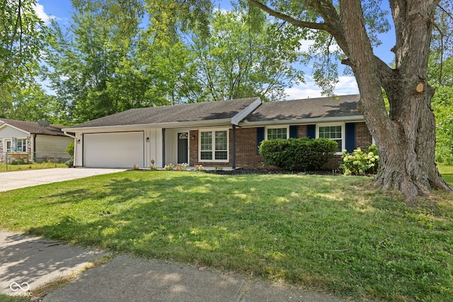 3102 Pawnee Dr, Indianapolis, IN 46235 - ranch-style home with driveway, a garage, brick siding, a front yard, and board and batten siding