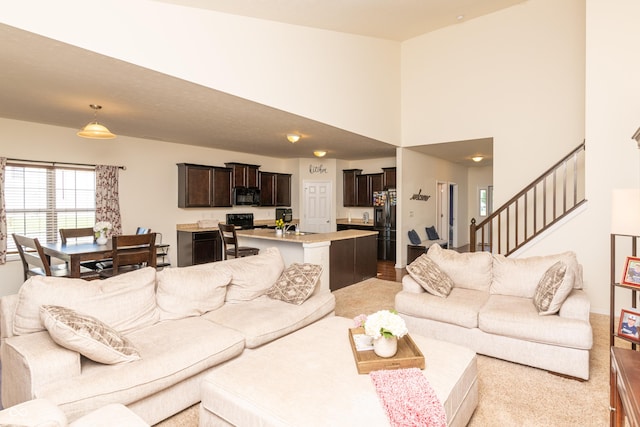 7626 Merrick Dr, Brownsburg, IN 46112 - living room featuring stairs and a high ceiling