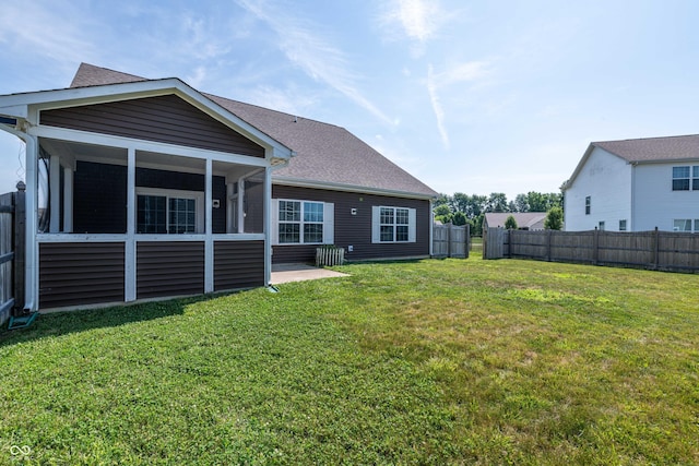 7626 Merrick Dr, Brownsburg, IN 46112 - rear view of property with a fenced backyard, a shingled roof, and a sunroom