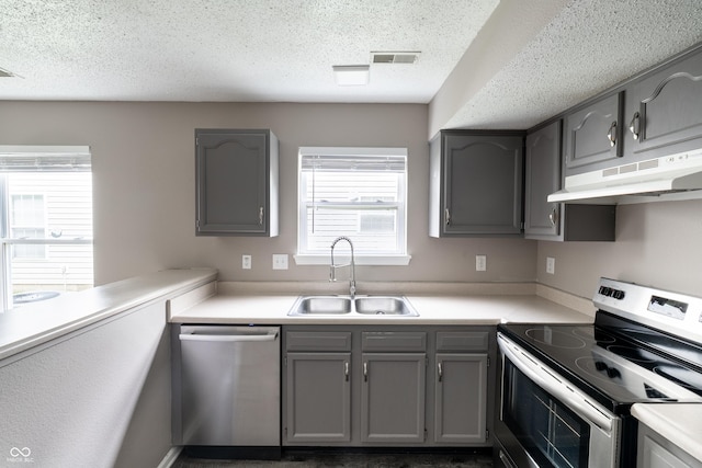 3307 Blue Ash, Indianapolis, IN 46239 - kitchen with appliances with stainless steel finishes, gray cabinetry, under cabinet range hood, light countertops, and a textured ceiling