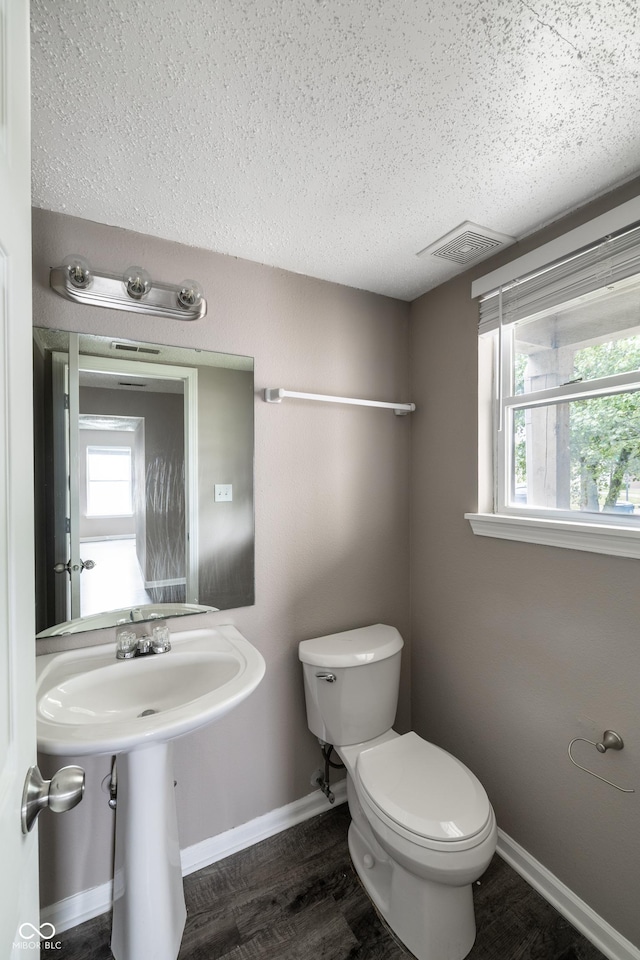 3307 Blue Ash, Indianapolis, IN 46239 - bathroom featuring a textured ceiling, healthy amount of natural light, and wood finished floors