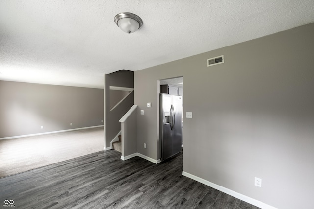 3307 Blue Ash, Indianapolis, IN 46239 - spare room featuring dark wood-type flooring, stairway, and a textured ceiling