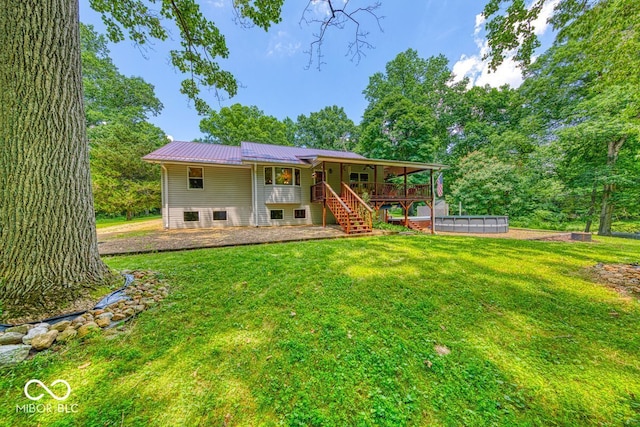 8910 Richarts Rd, Morgantown, IN 46160 - back of house with stairs, a metal roof, a yard, and a pool