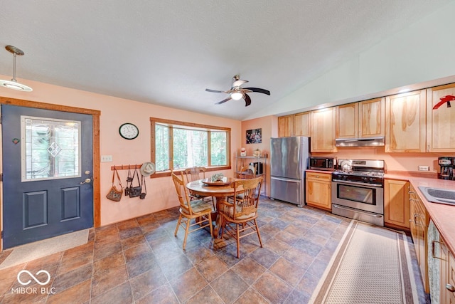8910 Richarts Rd, Morgantown, IN 46160 - kitchen with stainless steel appliances, under cabinet range hood, light brown cabinetry, light countertops, and lofted ceiling