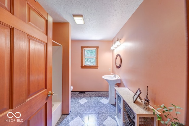 8910 Richarts Rd, Morgantown, IN 46160 - full bath with granite floors, a textured ceiling, and shower / bathtub combination