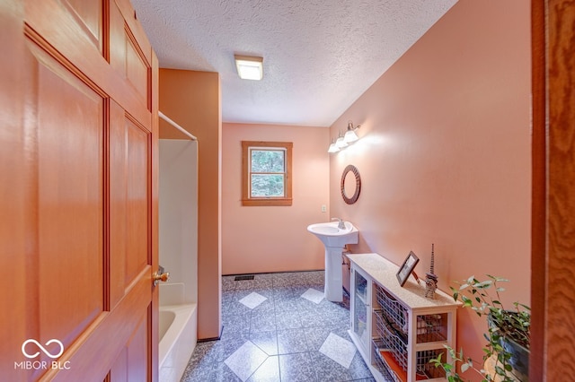 8910 Richarts Rd, Morgantown, IN 46160 - full bathroom with granite floors, bathing tub / shower combination, and a textured ceiling