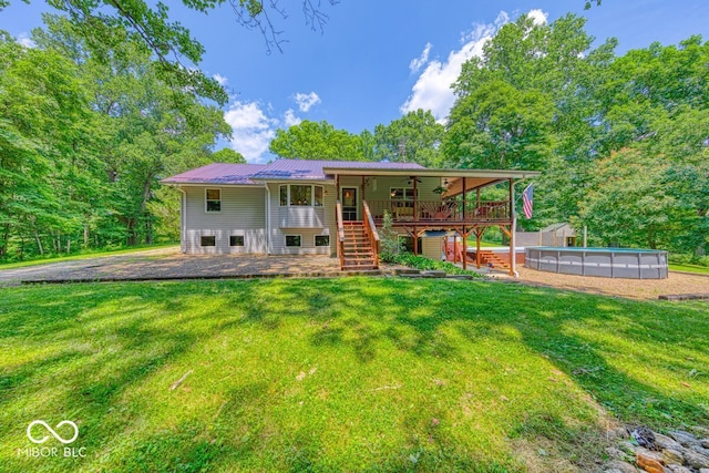 8910 Richarts Rd, Morgantown, IN 46160 - back of house featuring stairs, a lawn, an outdoor pool, and a wooden deck