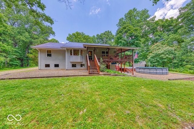 8910 Richarts Rd, Morgantown, IN 46160 - rear view of house featuring stairs, a lawn, and a metal roof