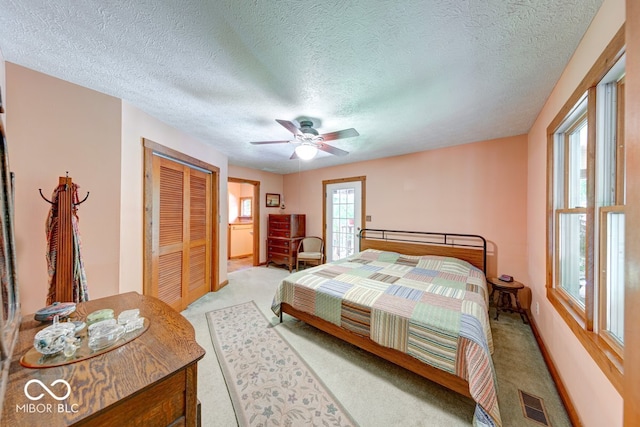 8910 Richarts Rd, Morgantown, IN 46160 - bedroom featuring light carpet, a closet, a textured ceiling, and a ceiling fan