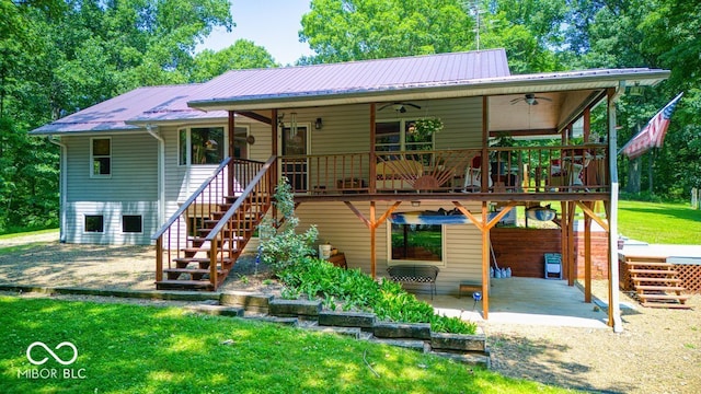 8910 Richarts Rd, Morgantown, IN 46160 - view of front of house featuring a ceiling fan, a patio area, stairs, a metal roof, and a front lawn