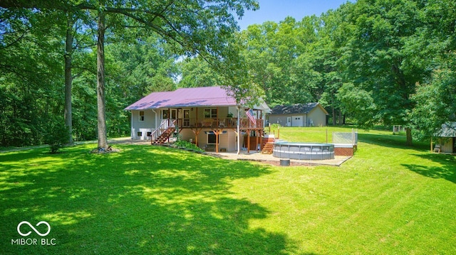 8910 Richarts Rd, Morgantown, IN 46160 - back of property with stairway, a deck, a yard, a metal roof, and a patio area