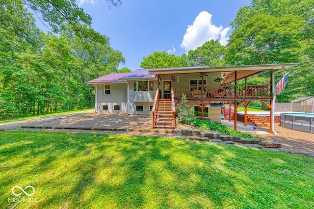 8910 Richarts Rd, Morgantown, IN 46160 - rear view of house featuring stairway, ceiling fan, a yard, and a deck