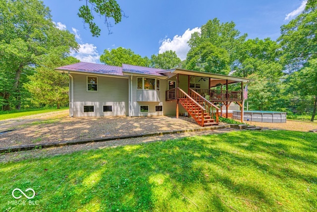 8910 Richarts Rd, Morgantown, IN 46160 - rear view of house with stairs, an outdoor pool, a yard, a patio area, and a metal roof