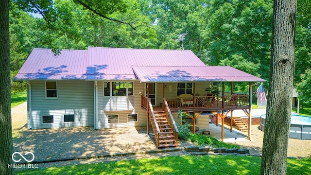 8910 Richarts Rd, Morgantown, IN 46160 - view of front of house with stairs, a patio area, a metal roof, and a wooden deck