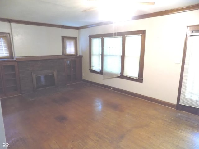 940 N Grant Ave, Indianapolis, IN 46201 - unfurnished living room featuring wood finished floors, a fireplace with flush hearth, and crown molding