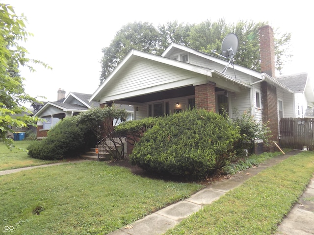 940 N Grant Ave, Indianapolis, IN 46201 - view of front of house featuring brick siding and a chimney